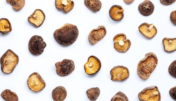 Dried shiitake mushrooms on white background.