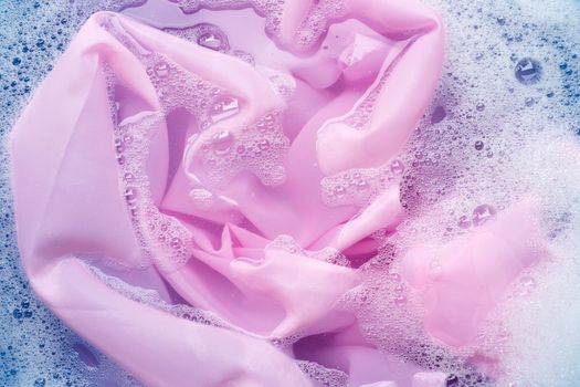 Color clothes soak in powder detergent water dissolution. Laundry concept
