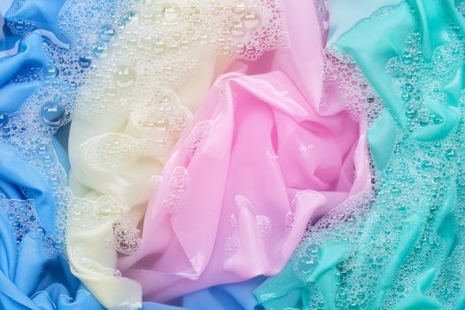 Color clothes soak in powder detergent water dissolution. Laundry concept