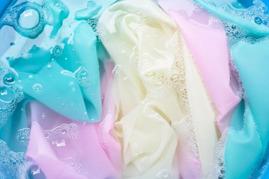 Color clothes soak in powder detergent water dissolution. Laundry concept