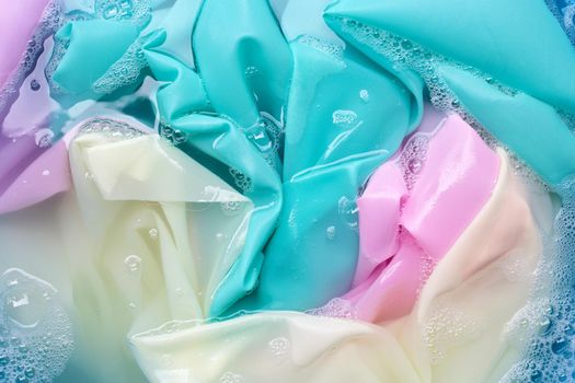 Color clothes soak in powder detergent water dissolution. Laundry concept