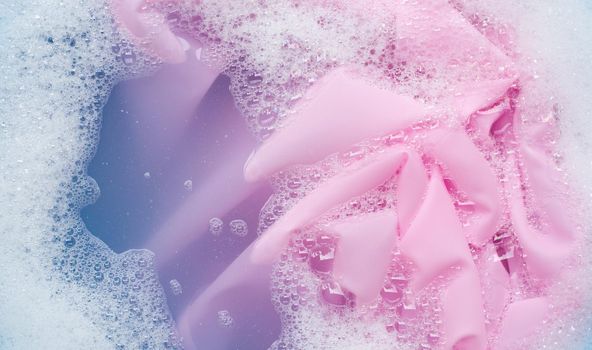 Color clothes soak in powder detergent water dissolution. Laundry concept
