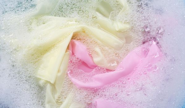Color clothes soak in powder detergent water dissolution. Laundry concept