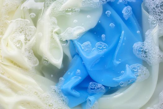 Color clothes soak in powder detergent water dissolution. Laundry concept