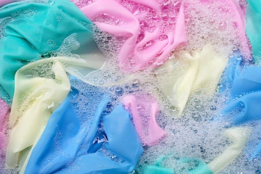 Color clothes soak in powder detergent water dissolution. Laundry concept