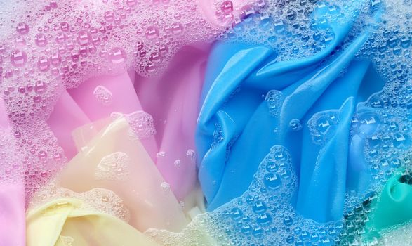 Color clothes soak in powder detergent water dissolution. Laundry concept