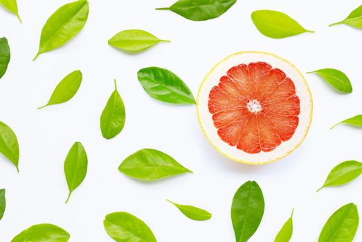 High vitamin C. Juicy grapefruit with leaves on white background. Copy space