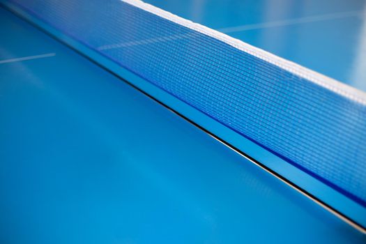 Net of table tennis ping pong on blue background.