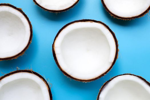 Half coconut on a blue background. Top view