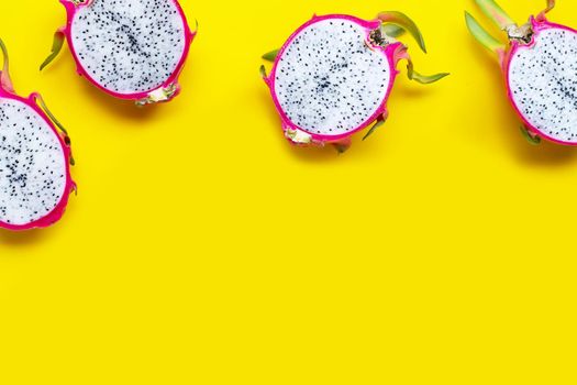 Dragon fruit or pitaya on yellow background. Top view