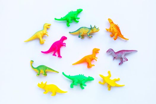 Plastic dinosaur toys on white background. Top view