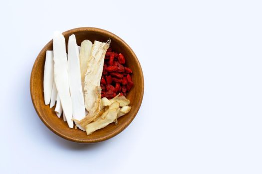 Mixed chinese herb in wooden bowl on white background. Copy space