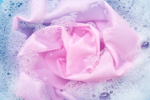 Color clothes soak in powder detergent water dissolution. Laundry concept