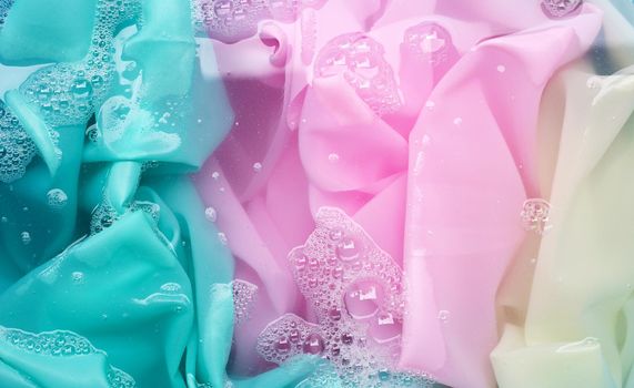 Color clothes soak in powder detergent water dissolution. Laundry concept
