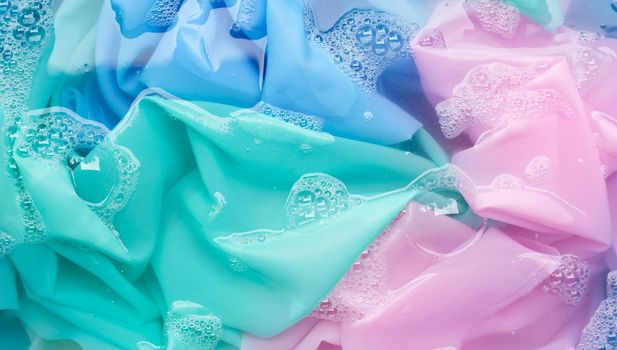 Color clothes soak in powder detergent water dissolution. Laundry concept