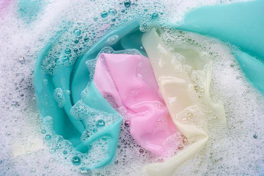 Color clothes soak in powder detergent water dissolution. Laundry concept