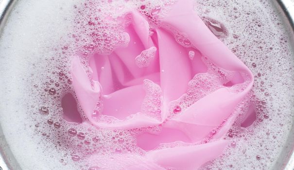 Color clothes soak in powder detergent water dissolution. Laundry concept