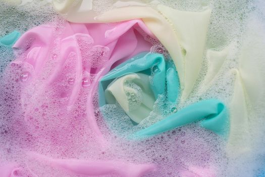Color clothes soak in powder detergent water dissolution. Laundry concept