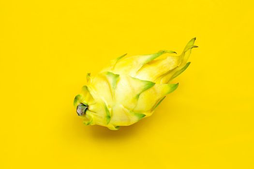 Yellow pitahaya or dragon fruit on yellow background.  Top view