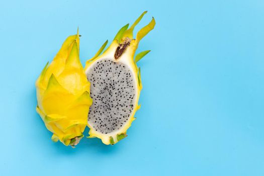 Yellow pitahaya or dragon fruit on blue background. Copy space