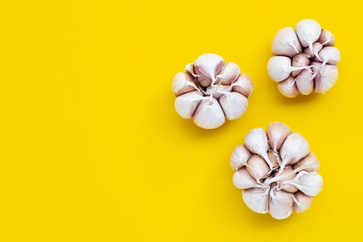 Cooking ingredients, Garlic on yellow background. Healthy eating concept