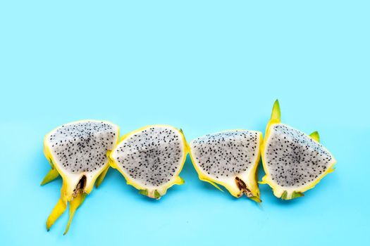 Yellow pitahaya or dragon fruit on blue background.  Top view