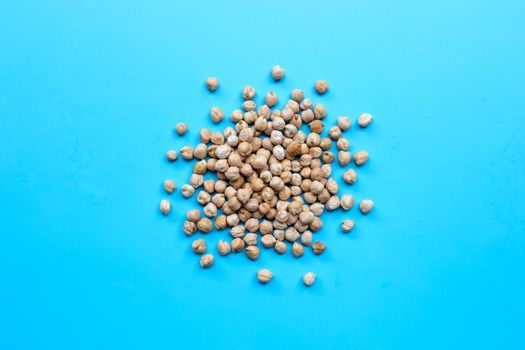 Chickpeas on blue background. Top view