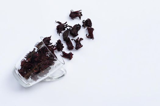 Glass with dried roselle flower isolated on white background. Top viewTop view