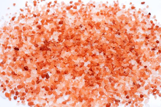 Pink himalayan salt on white background. 