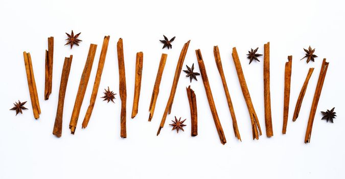 Star anis and cinnamon sticks on white background.