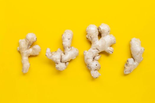 Ginger on yellow background. Top view
