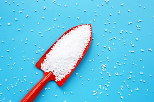 Chemical plant urea fertilizer on blue background. 
