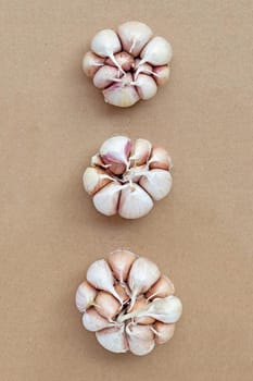 Cooking ingredients, Garlic on brown paper background. Healthy eating concept