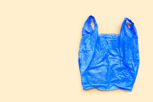 Colorful plastic bags on yellow background. Copy space