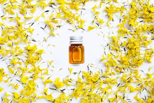 Essential oil of marigold flower on white