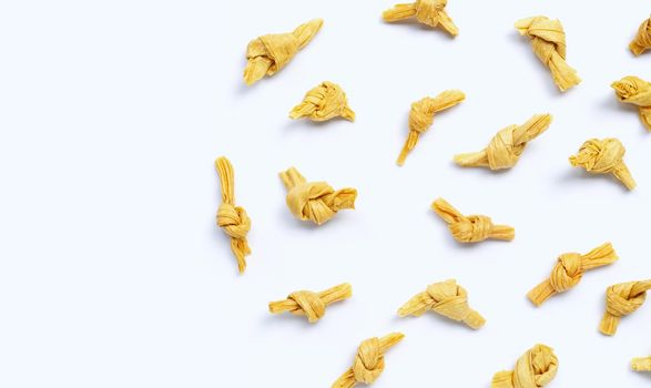 Dried bean curd knot on white background. Copy space
