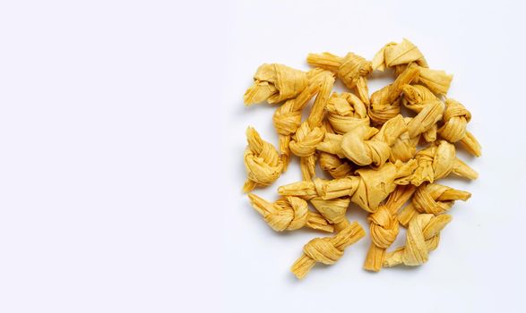 Dried bean curd knot on white background. Copy space