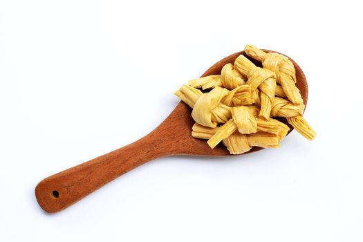 Dried bean curd knot on woon spoon on white background. Copy space
