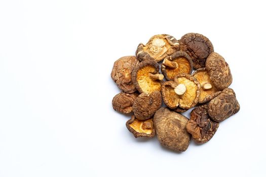 Dried shiitake mushrooms on white background.