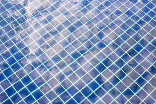 Water swimming pool surface for background. Reflection of blue sky with clouds