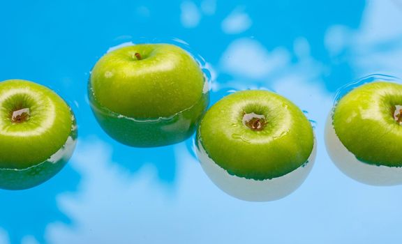Washing fresh green apples in the water
