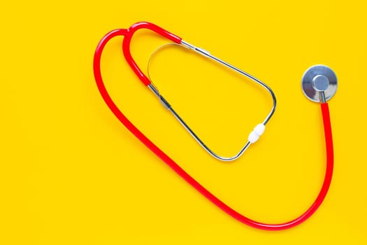 Stethoscope on yellow background. copy space