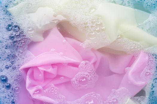 Color clothes soak in powder detergent water dissolution. Laundry concept