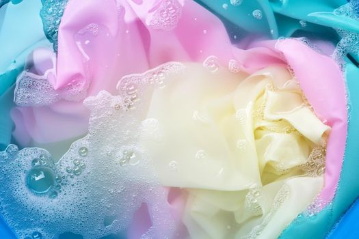 Color clothes soak in powder detergent water dissolution. Laundry concept