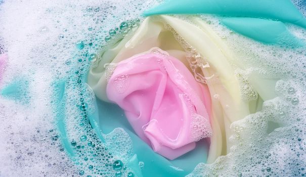 Color clothes soak in powder detergent water dissolution. Laundry concept