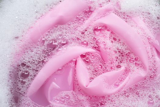 Color clothes soak in powder detergent water dissolution. Laundry concept