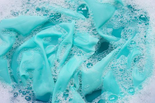 Color clothes soak in powder detergent water dissolution. Laundry concept