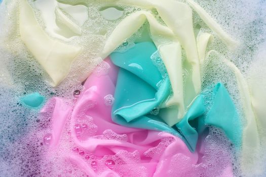 Color clothes soak in powder detergent water dissolution. Laundry concept