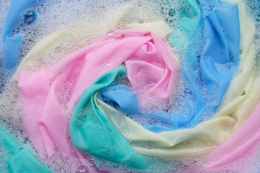 Color clothes soak in powder detergent water dissolution. Laundry concept
