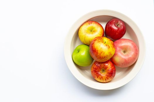 Ripe apples in bowl on white background. Top view